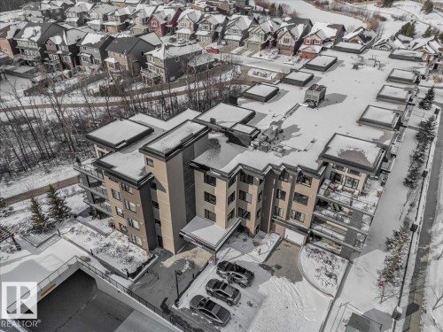 This property features a multi-story building with balconies and an underground parking garage - 211 5029 Edgemont Boulevard, Edmonton, AB - 