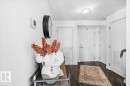 Entryway featuring dark wood flooring, white walls, and white doors - 211 5029 Edgemont Boulevard, Edmonton, AB  - Indoor Photo Showing Other Room 