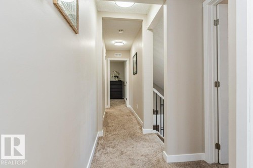 Hallway featuring neutral wall tones, low-pile carpeting, recessed lighting, and white trim - 1727 65 Street, Edmonton, AB - Indoor Photo Showing Other Room