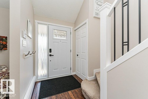 Entryway featuring a paneled door with decorative glass insert and sidelight - 1727 65 Street, Edmonton, AB - Indoor Photo Showing Other Room