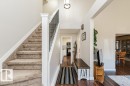 Two-story foyer with a vaulted ceiling and a drum pendant light fixture - 1727 65 Street, Edmonton, AB  - Indoor Photo Showing Other Room 