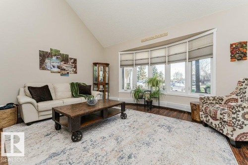 Vaulted ceiling above a bright living area featuring a prominent bay window - 1727 65 Street, Edmonton, AB - Indoor Photo Showing Living Room