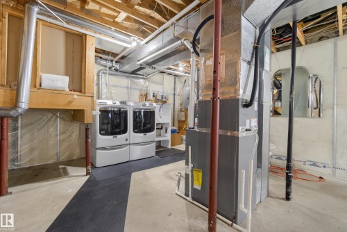 Unfinished basement area featuring exposed ceiling joists, ductwork, and foundation walls - 720 87 Street, Edmonton, AB - Indoor