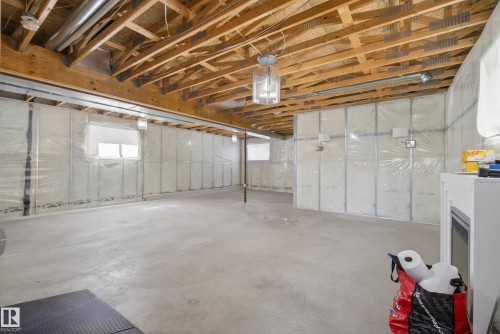 Expansive unfinished basement featuring an open wood beam ceiling, concrete flooring, and insulated walls - 720 87 Street, Edmonton, AB - Indoor Photo Showing Basement