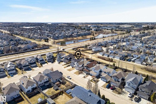Aerial perspective showcasing a residential neighborhood with numerous detached homes, each featuring individual driveways and pitched roofs - 720 87 Street, Edmonton, AB - Outdoor With View