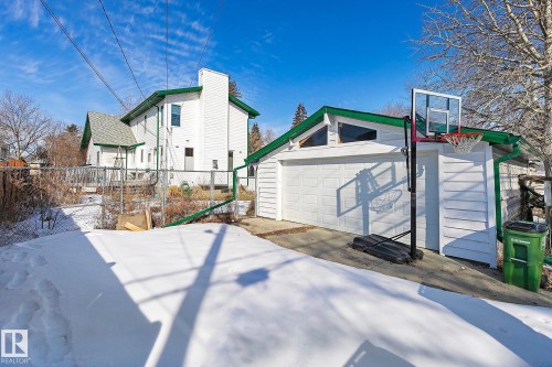 The property features an detached garage with a white garage door and siding - 10823 130 Street, Edmonton, AB - Outdoor With Exterior