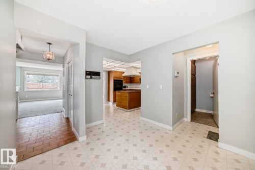 Entry area featuring patterned vinyl flooring, a contemporary ceiling light fixture, and light gray wall paint - 2709 124 Street, Edmonton, AB - Indoor Photo Showing Other Room
