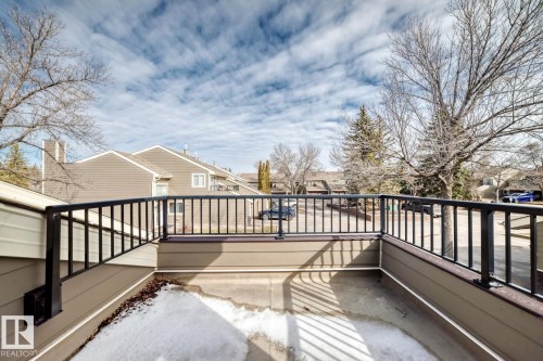 Outdoor deck featuring dark metal railings and a composite-style floor - 2709 124 Street, Edmonton, AB - Outdoor With Balcony