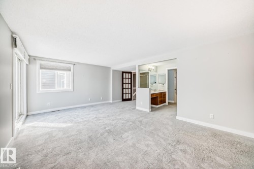 Spacious carpeted room featuring light gray walls and white trim - 2709 124 Street, Edmonton, AB - Indoor Photo Showing Other Room