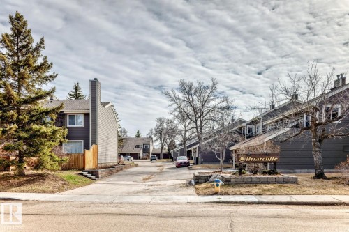 Gray siding exterior with multiple pitched roofs - 2709 124 Street, Edmonton, AB - Outdoor