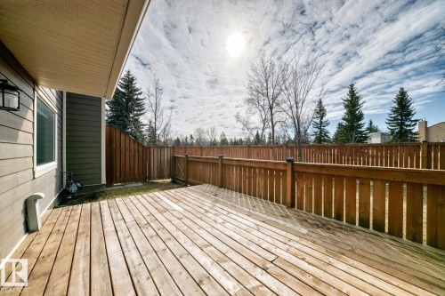 Expansive outdoor deck crafted from light-toned wood planks, featuring a perimeter wood fence - 2709 124 Street, Edmonton, AB - Outdoor With Deck Patio Veranda With Exterior