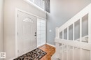 Foyer featuring a white entry door with an arched transom, a sidelight with glass blocks, and terracotta tile flooring - 2709 124 Street, Edmonton, AB  - Indoor Photo Showing Other Room 