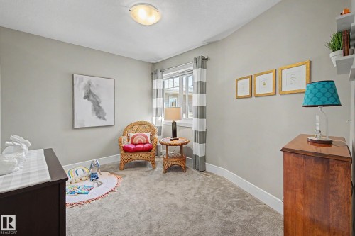 Carpeted room featuring light gray walls, white baseboards, and a window with white trim - 2086 Redtail Common, Edmonton, AB - Indoor