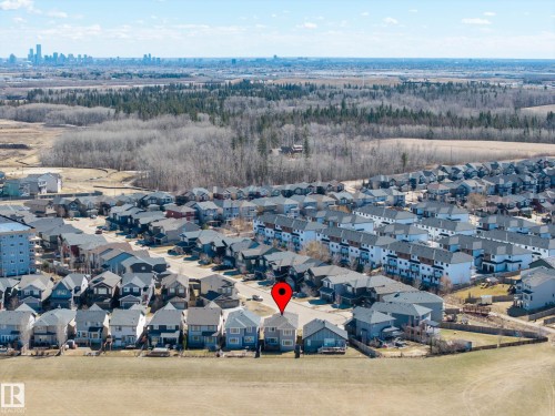 Aerial perspective showcasing a residential development with a city skyline in the distance - 2086 Redtail Common, Edmonton, AB - Outdoor With View