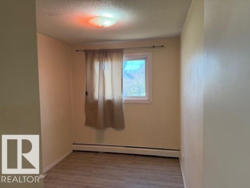 Room featuring light-colored walls, a window with a curtain, and light-toned flooring - 201 10811 115 Street, Edmonton, AB - Indoor Photo Showing Other Room