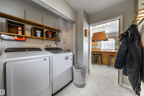 Dedicated laundry area featuring a white dryer and washing machine - 10231 46 Street, Edmonton, AB - Indoor Photo Showing Laundry Room