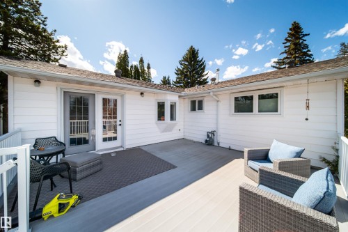Expansive L-shaped deck featuring composite decking and white railings - 10231 46 Street, Edmonton, AB - Outdoor With Deck Patio Veranda With Exterior