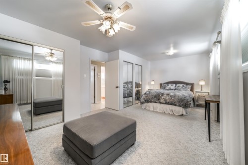 Bright bedroom featuring wall-to-wall carpeting and white walls - 10231 46 Street, Edmonton, AB - Indoor Photo Showing Bedroom