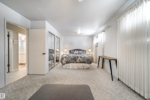 Carpeted bedroom featuring white walls and a ceiling fan - 10231 46 Street, Edmonton, AB - Indoor Photo Showing Bedroom