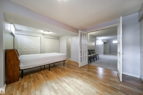 Finished room featuring wood-finish flooring, bi-fold closet doors, and recessed lighting - 10231 46 Street, Edmonton, AB - Indoor Photo Showing Other Room