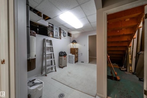 Utility space with dropped ceiling, exposed conduit, and electrical panels - 10231 46 Street, Edmonton, AB - Indoor Photo Showing Basement