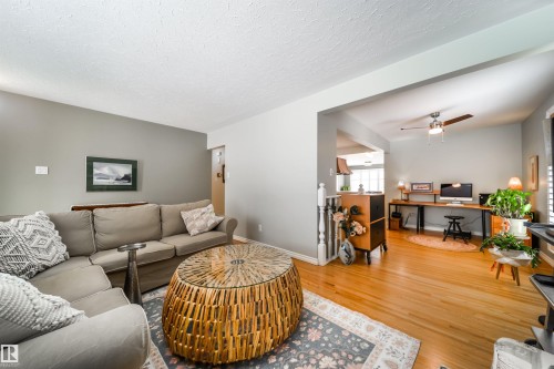 Bright interior space featuring light wood-finish flooring throughout - 10231 46 Street, Edmonton, AB - Indoor Photo Showing Living Room