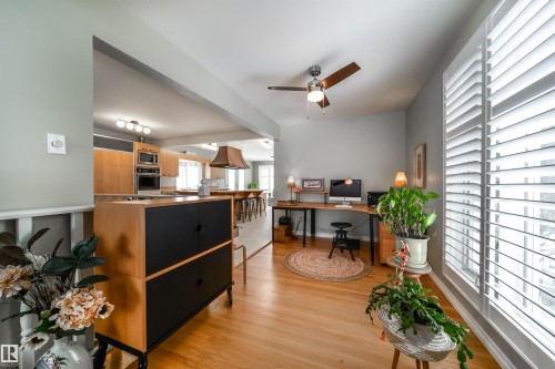 Hardwood flooring extending through an open-concept layout - 10231 46 Street, Edmonton, AB - Indoor