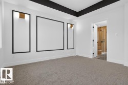 Spacious room featuring broadloom carpeting and a tray ceiling with a black accent trim - 