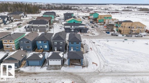 New construction development featuring a mix of completed and under-construction properties, modern architectural styles, and various exterior finishes - 55 Rosa Crescent, St. Albert, AB - Outdoor