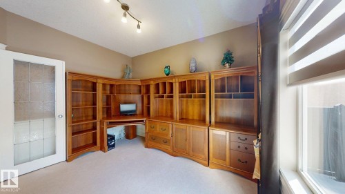 This room features light-colored carpeting and walls, track lighting, and a window with blinds - 613 Todd Link, Edmonton, AB - Indoor Photo Showing Other Room