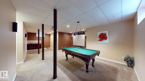 Spacious recreational area featuring carpeted flooring, recessed lighting, and a built-in wet bar with a countertop - 613 Todd Link, Edmonton, AB - Indoor Photo Showing Other Room