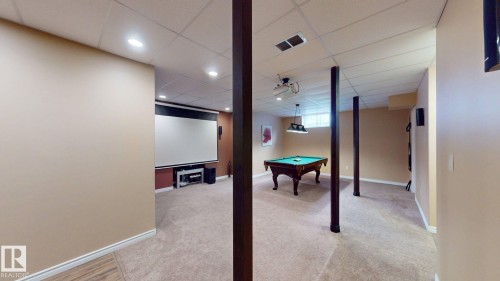 The property features a spacious room with carpeted flooring, recessed lighting, and a drop ceiling - 613 Todd Link, Edmonton, AB - Indoor Photo Showing Other Room