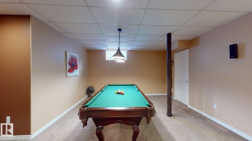 Recreation room featuring carpeted flooring, light beige and accent brown walls, and a dropped ceiling with recessed lighting - 613 Todd Link, Edmonton, AB - Indoor Photo Showing Other Room
