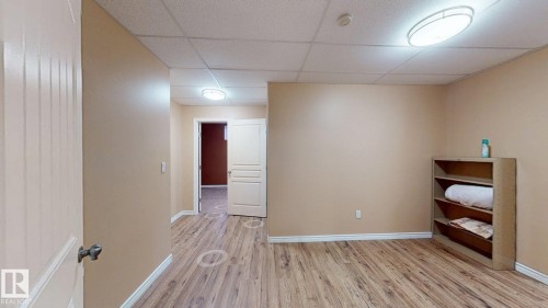 Interior space featuring light brown walls, wood-look flooring, and recessed ceiling lights - 613 Todd Link, Edmonton, AB - Indoor
