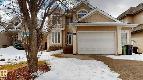 The property features a two-car garage, a paved driveway, and a front entrance with steps leading to the door - 613 Todd Link, Edmonton, AB - Outdoor With Facade