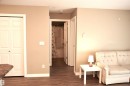 Wood-finish flooring throughout, complemented by light neutral wall tones and white trim - 103 920 156 Street Nw, Edmonton, AB  - Indoor 