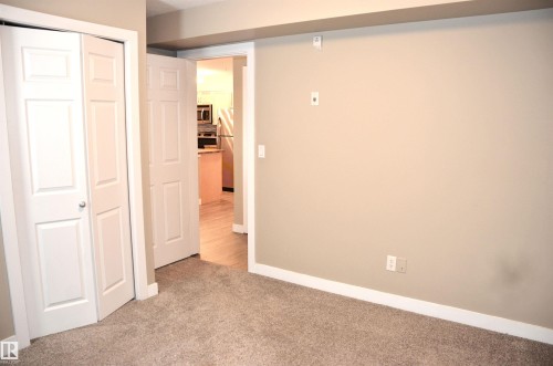 Neutral-toned walls complement the plush carpet flooring - 103 920 156 Street Nw, Edmonton, AB - Indoor Photo Showing Other Room