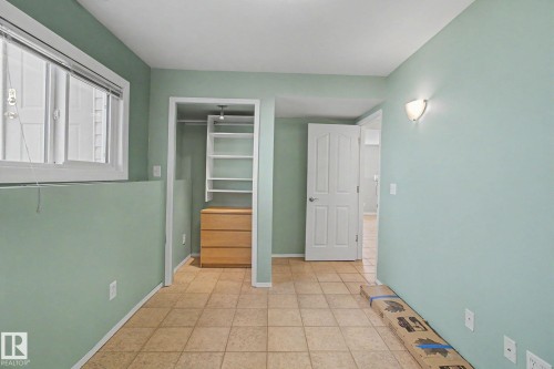 Room featuring light green walls and square tile flooring - 3903 32 Street, Edmonton, AB - Indoor Photo Showing Other Room