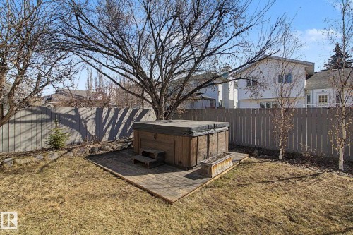 Backyard hot tub on a wooden deck with integrated steps - 3903 32 Street, Edmonton, AB - Outdoor