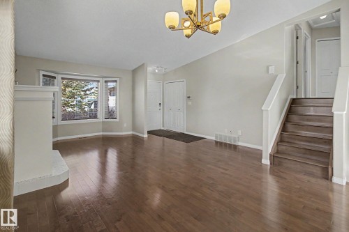 Expansive living area featuring rich wood-finish flooring - 3903 32 Street, Edmonton, AB - Indoor Photo Showing Other Room
