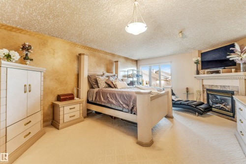 8715 160A Avenue, Edmonton, AB - Indoor Photo Showing Bedroom With Fireplace