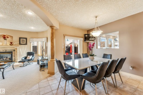 8715 160A Avenue, Edmonton, AB - Indoor Photo Showing Dining Room With Fireplace