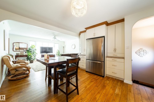 Kitchen and living space featuring wood-finish flooring - 8932 154 Street, Edmonton, AB - Indoor
