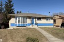 Ranch-style exterior featuring a bay window, a concrete walkway, and a prominent blue lower facade accent - 8932 154 Street, Edmonton, AB  - Outdoor 
