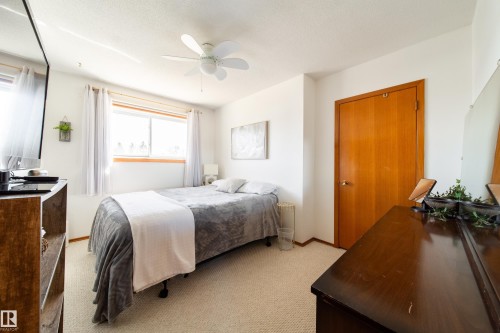 Bedroom featuring light-toned carpeting and a ceiling fan - 8932 154 Street, Edmonton, AB - Indoor Photo Showing Bedroom