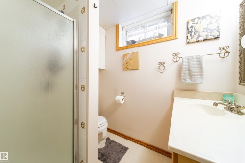 Bathroom vanity with a single sink, chrome faucet, and integrated countertop - 8932 154 Street, Edmonton, AB - Indoor Photo Showing Bathroom