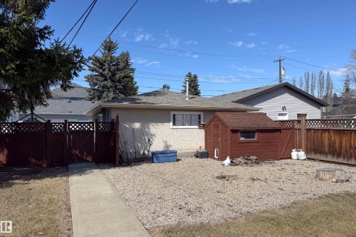 Gravel patio featuring a standalone shed and perimeter fencing - 8932 154 Street, Edmonton, AB - Outdoor