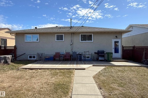 Spacious backyard featuring a multi-level wood deck and a concrete pathway - 8932 154 Street, Edmonton, AB - Outdoor With Exterior