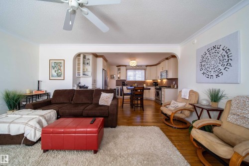 Living area with a textured ceiling, a ceiling fan, and crown molding - 8932 154 Street, Edmonton, AB - Indoor Photo Showing Living Room