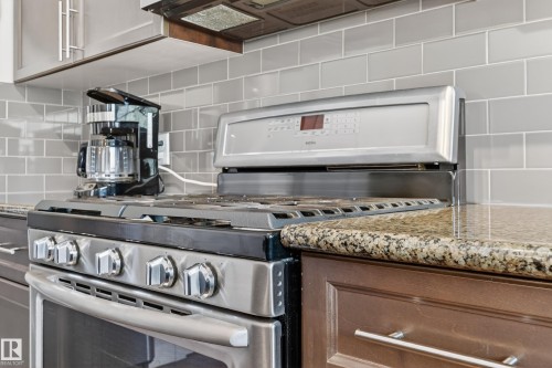 Stainless steel range with digital controls - 1786 Cunningham Way Sw, Edmonton, AB - Indoor Photo Showing Kitchen